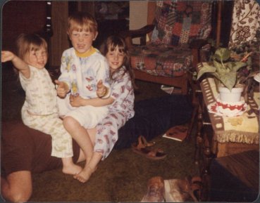 Me, my brother and our middle younger sister sitting on our dad - his idea of back massage.